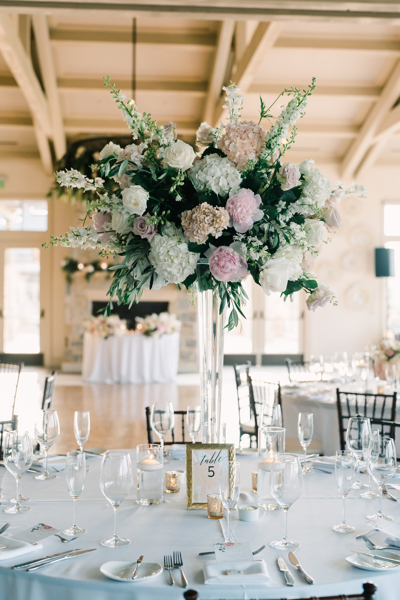 Tall elegant floral centerpiece at a wedding reception