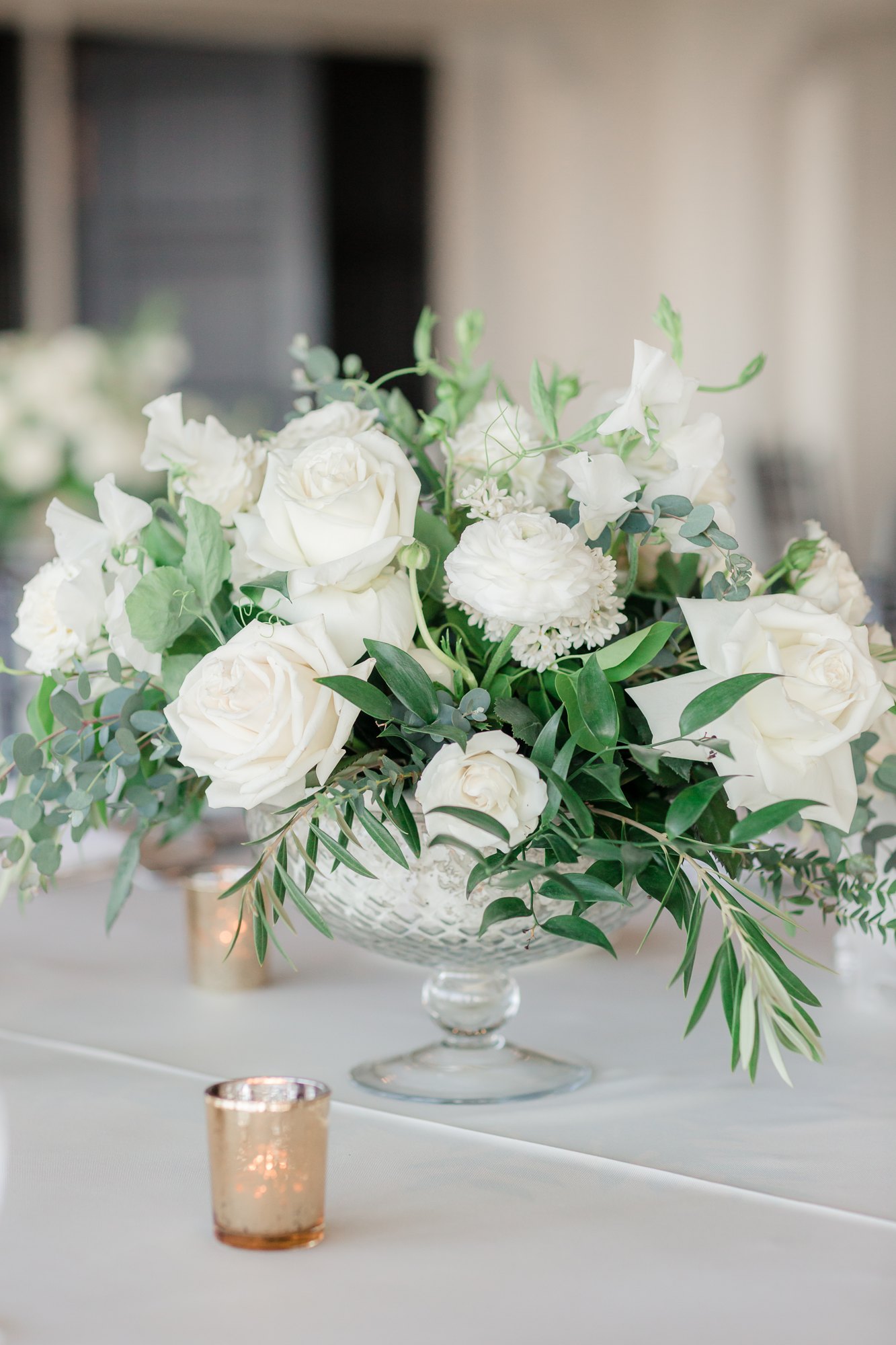 White and greenery bouquet styled with a candle