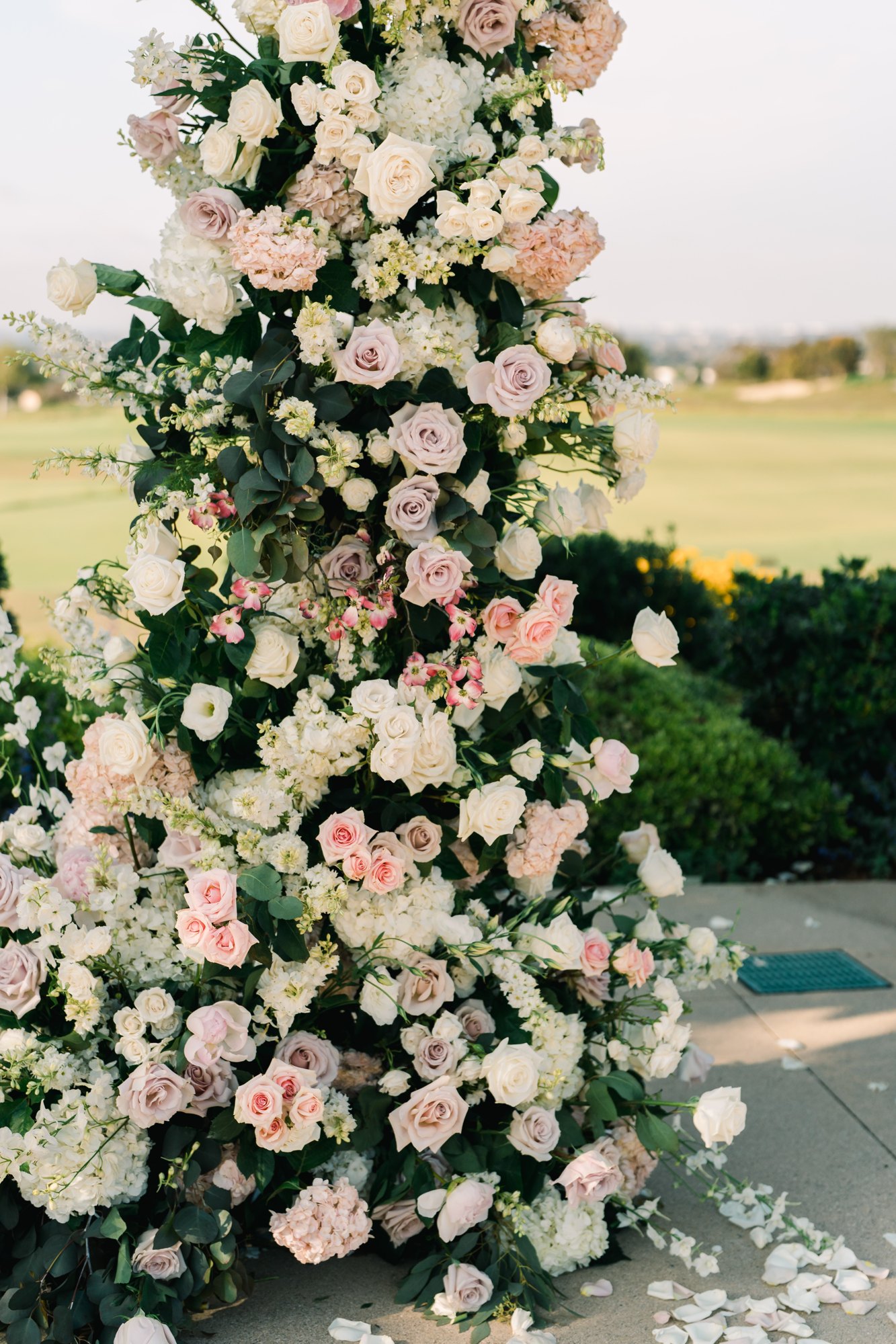 Tall blush floral pillar at a wedding ceremony